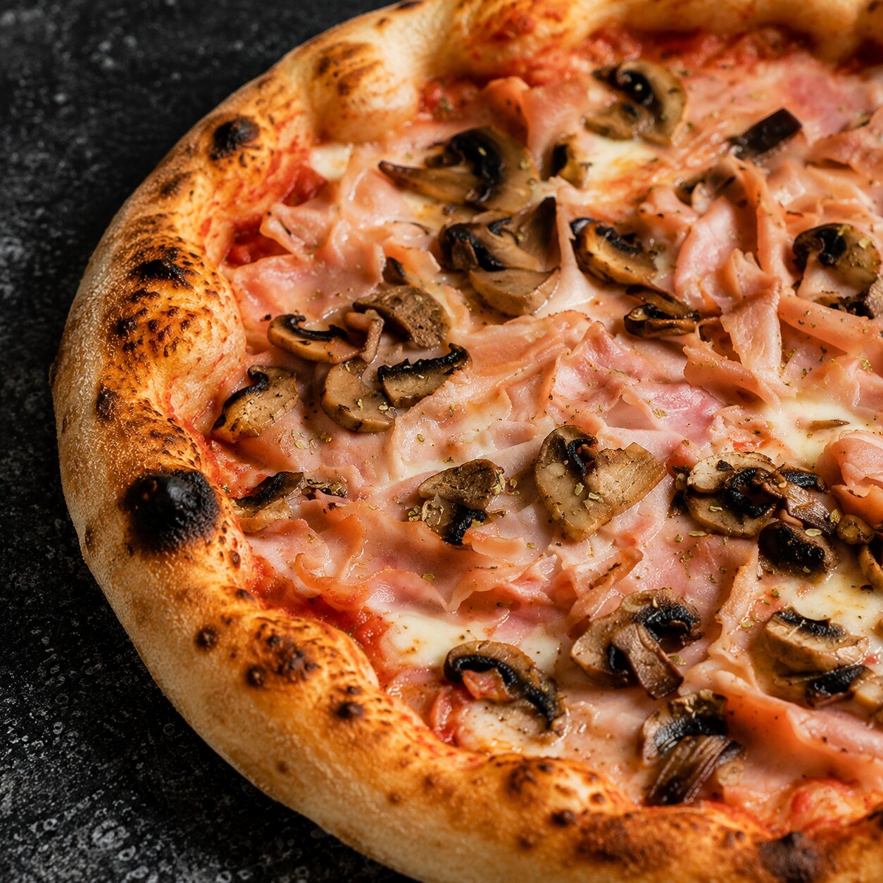 Close-up of Prosciutto e Funghi pizza with ham and mushroom